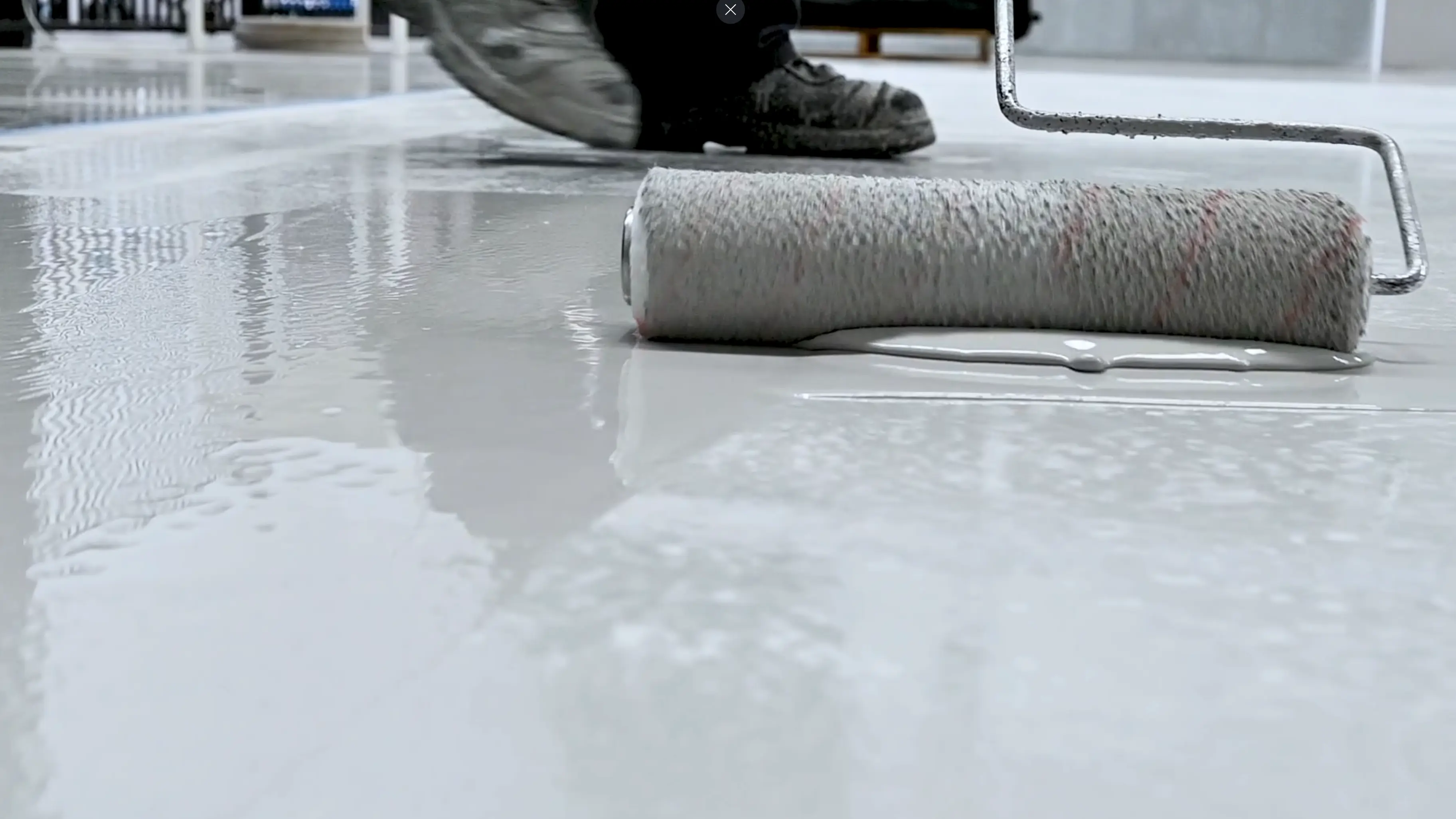 Working white epoxy in sections with a roller brush